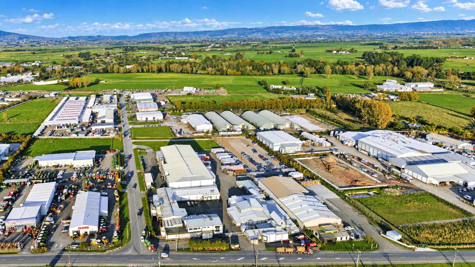Industrial and distribution businesses on the edge of Palmerston North with the Manawatū plains behind
